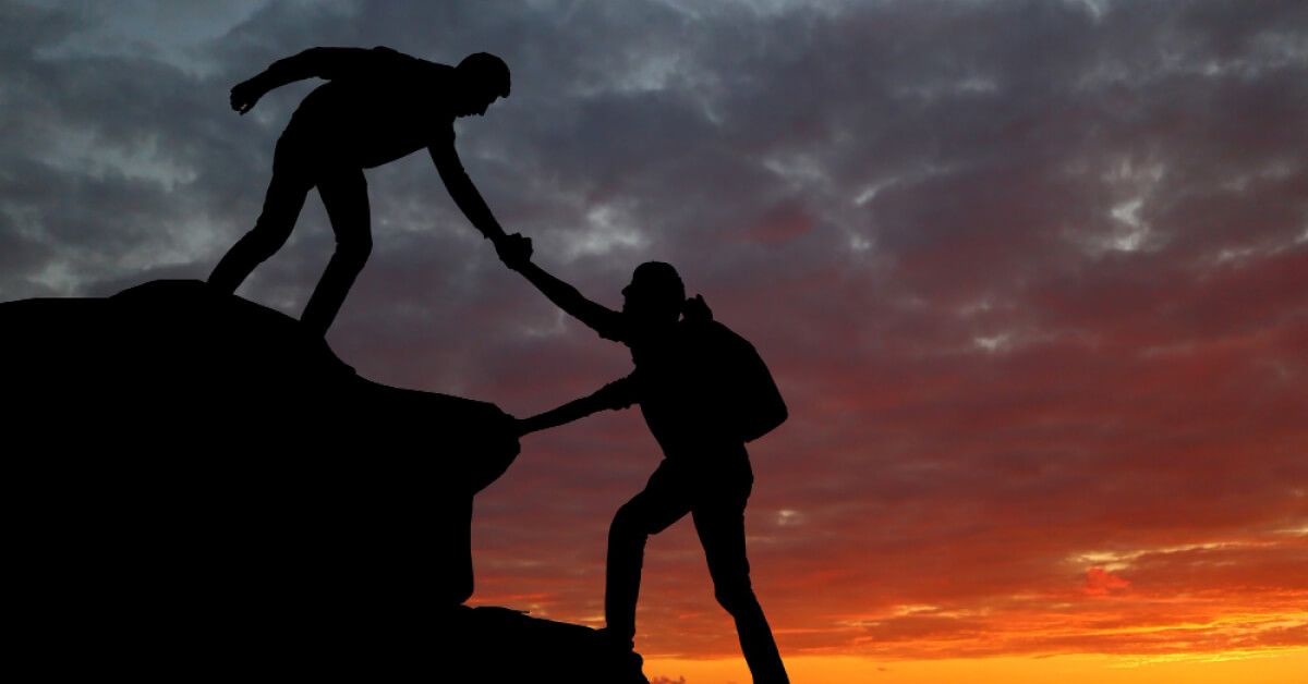 Teamwork couple hiking help each other trust assistance