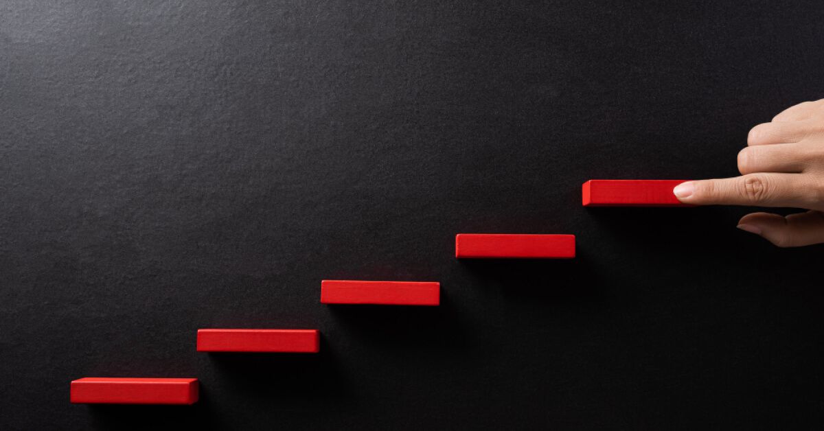Red blocks being placed in a stepwise manner