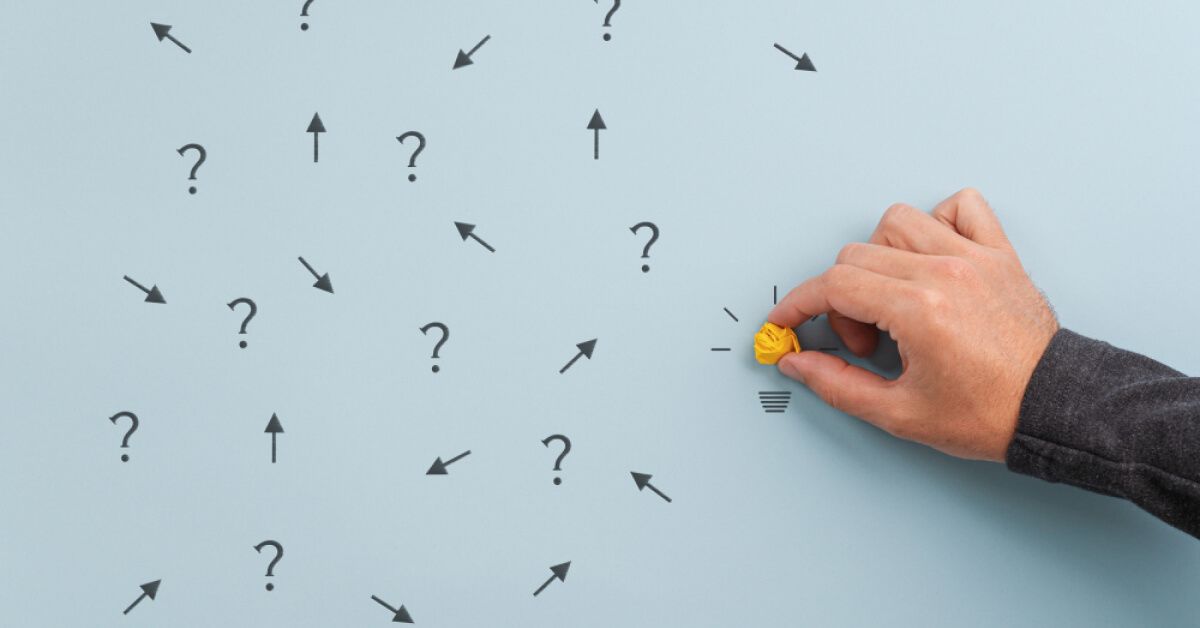 Person placing a crushed up yellow paper ball next to a series of vector visuals