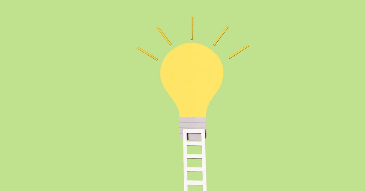 Paper leader leading up to a lightbulb