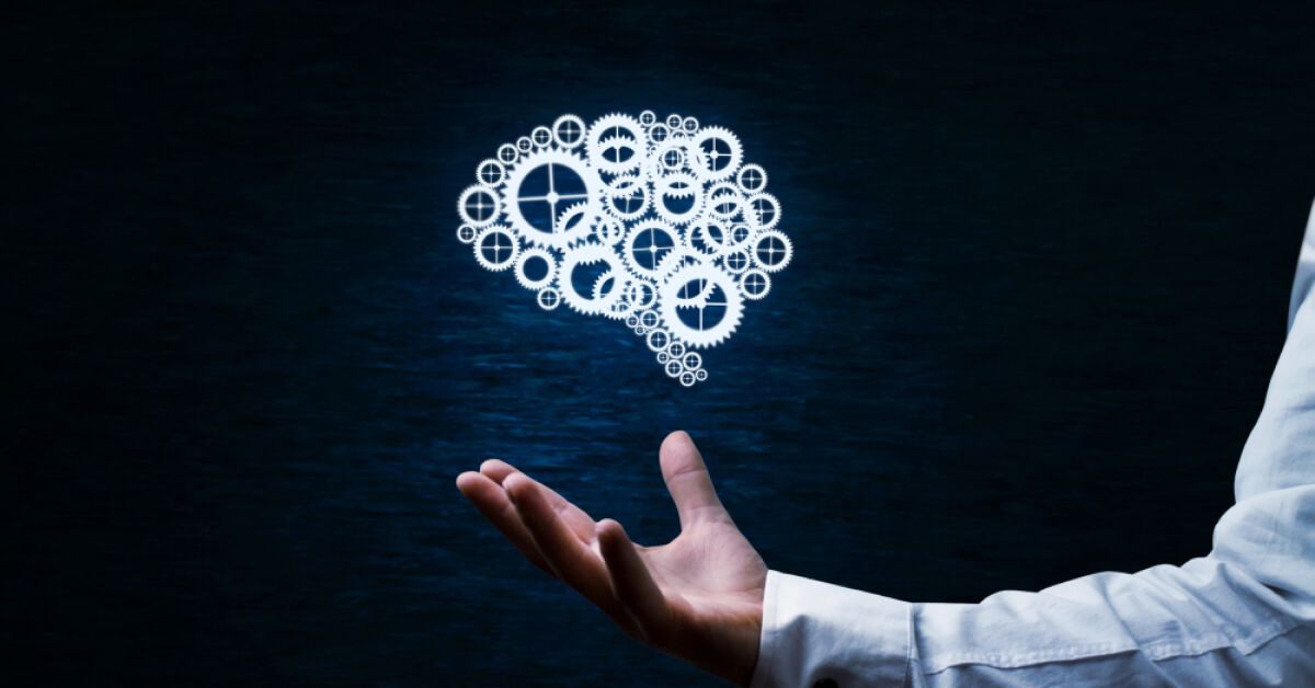 Person holding a holographic mechanical brain