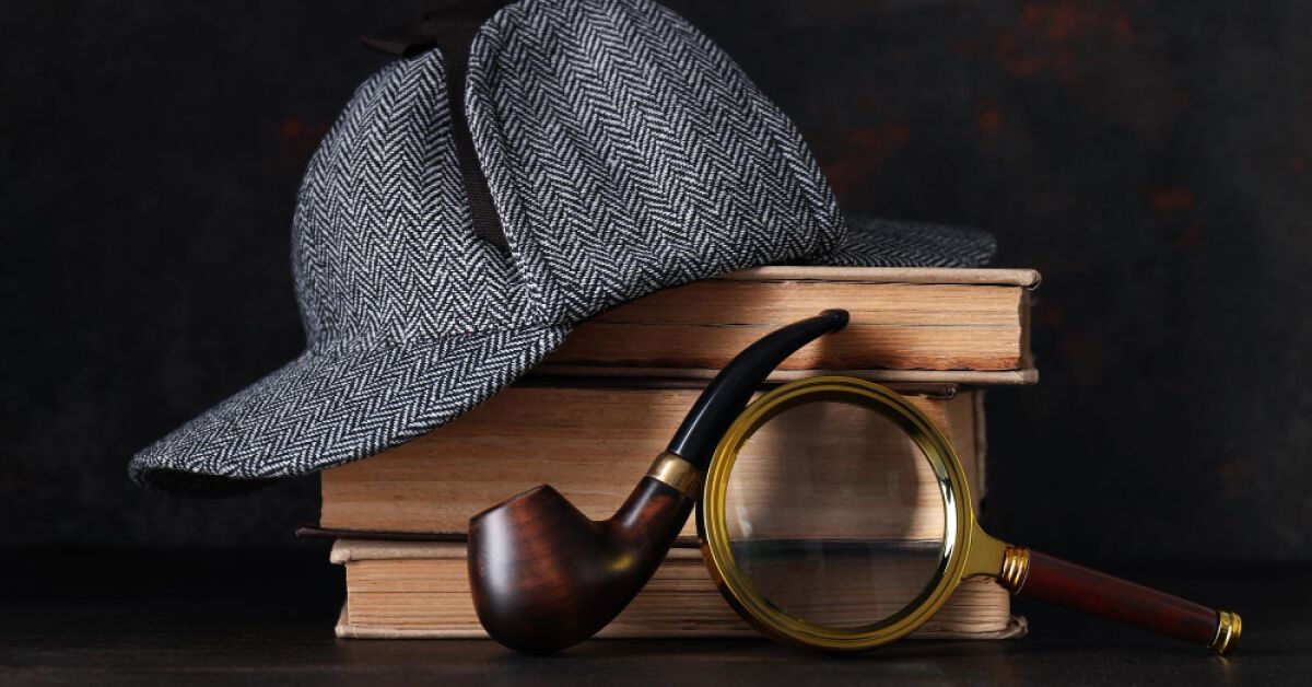 Detective's accessories against a stack of books