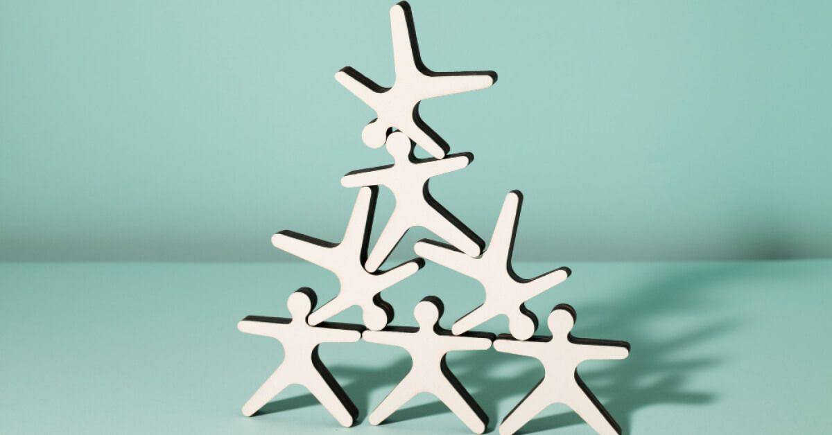 One stack of plastic man, falling on a pyramid of plastic men