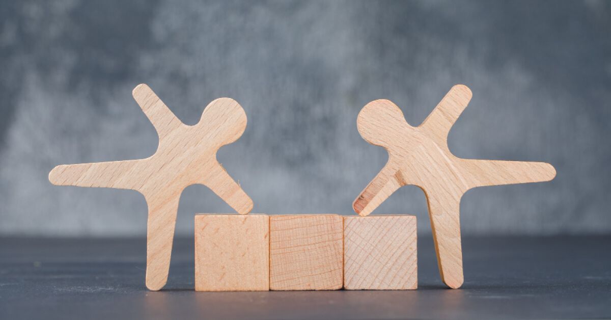 Wooden figurines alongside wooden blocks