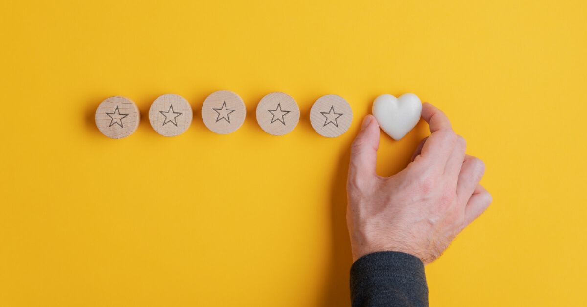 Person placing a heart shaped chip next to a series of chips with stars