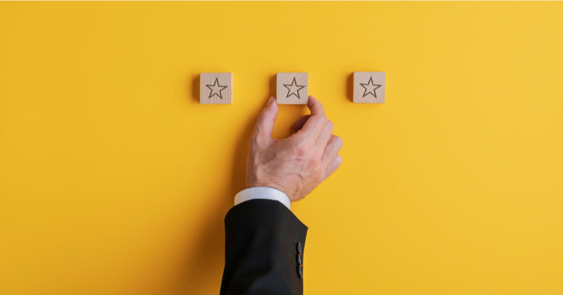 Person placing a wooden chip with a star icon next to a series of other chips