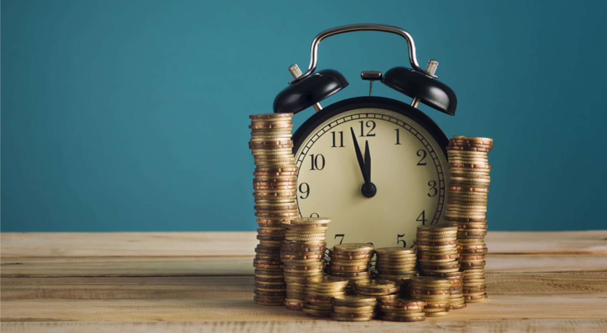 Clock and coins against a blue background