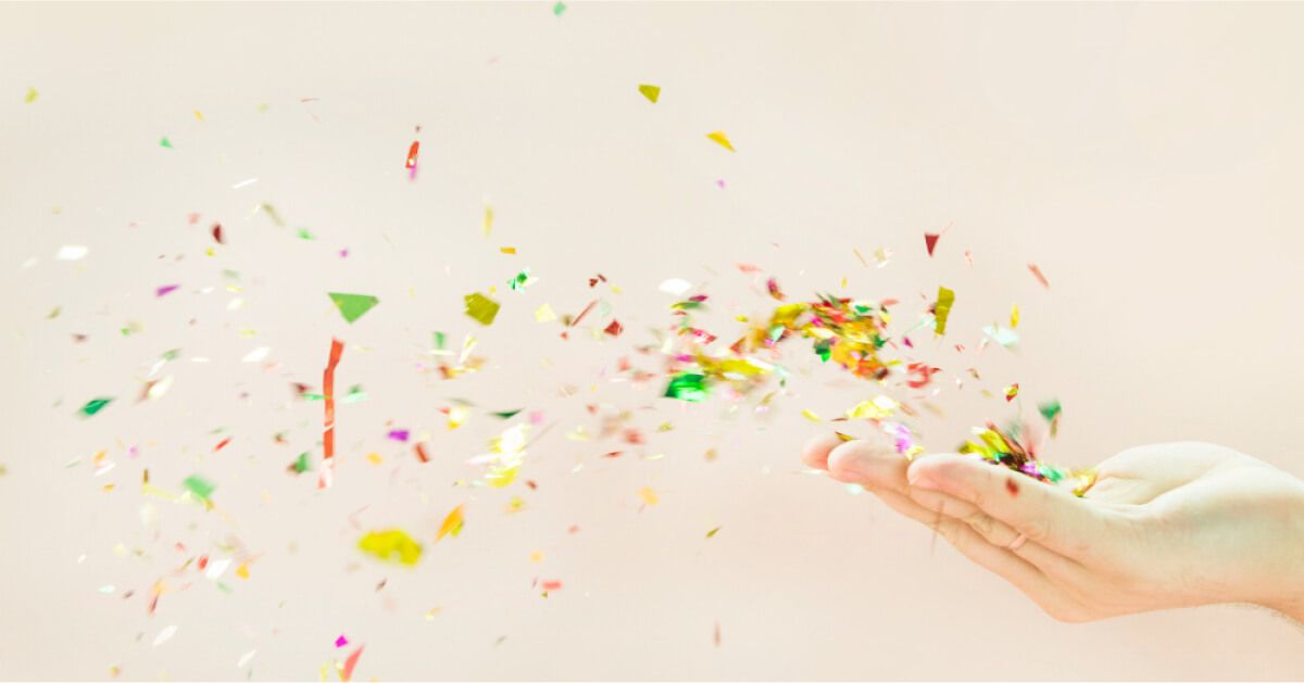 Confetti being blown off someone's palm