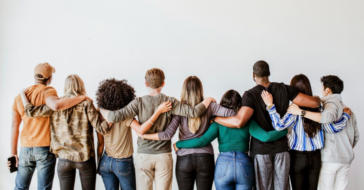 Diverse set of employees with hands around each other