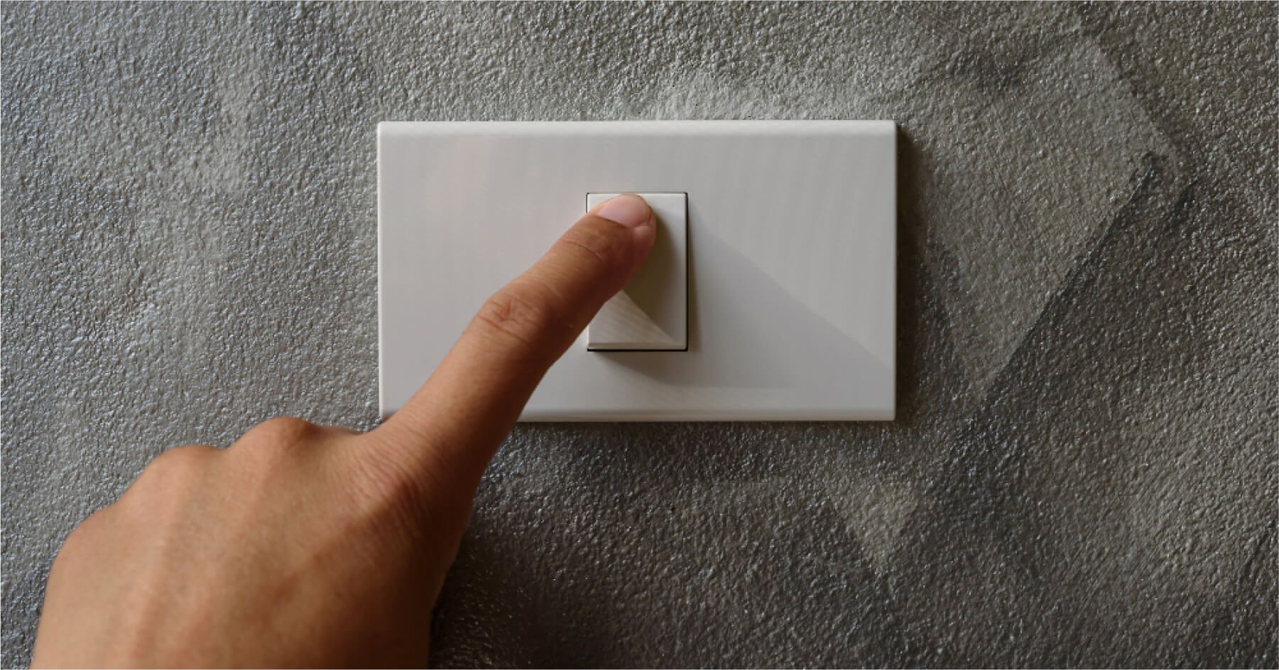 Finger is turning on or off on light switch