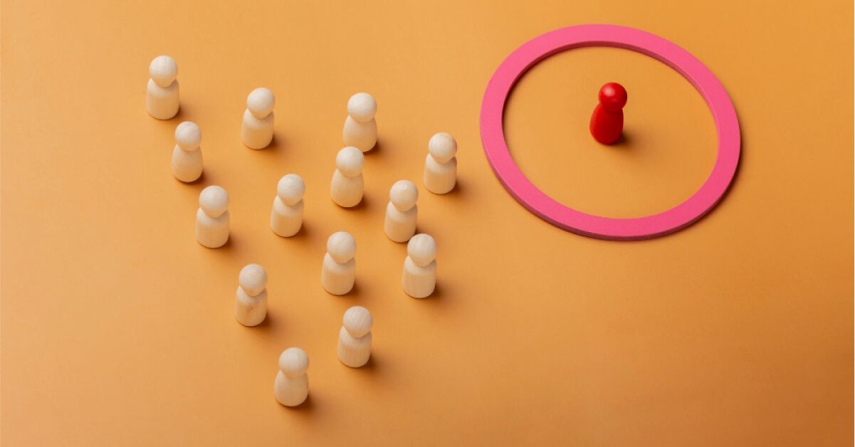 A red game piece alienated with a circle amongst other white game pieces