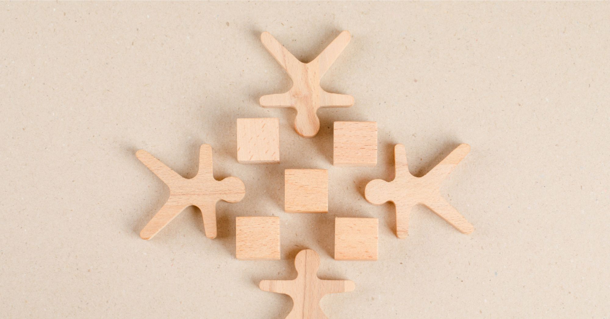 Wooden blocks of humans and squares arranged symmetrically