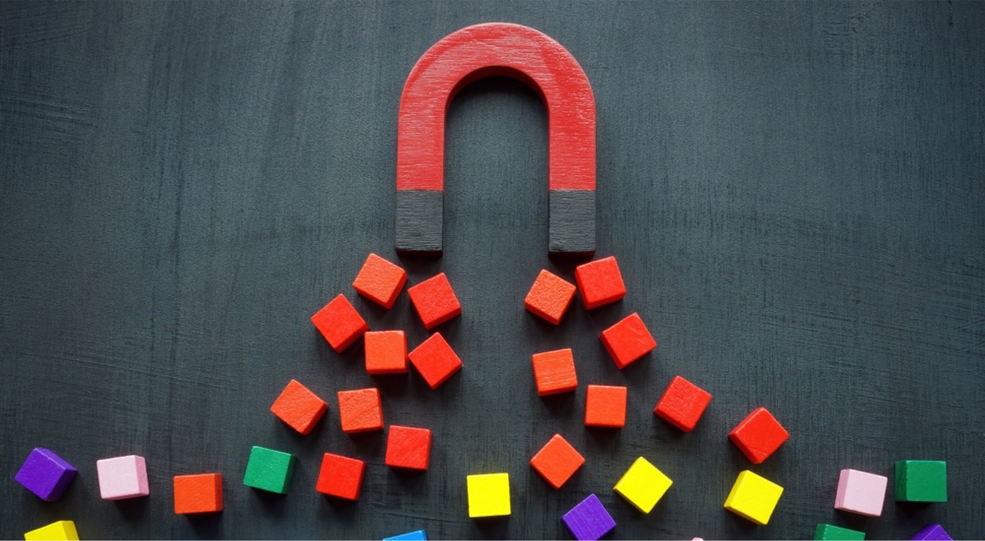 A giant magnet attracting cubes of multiple colours