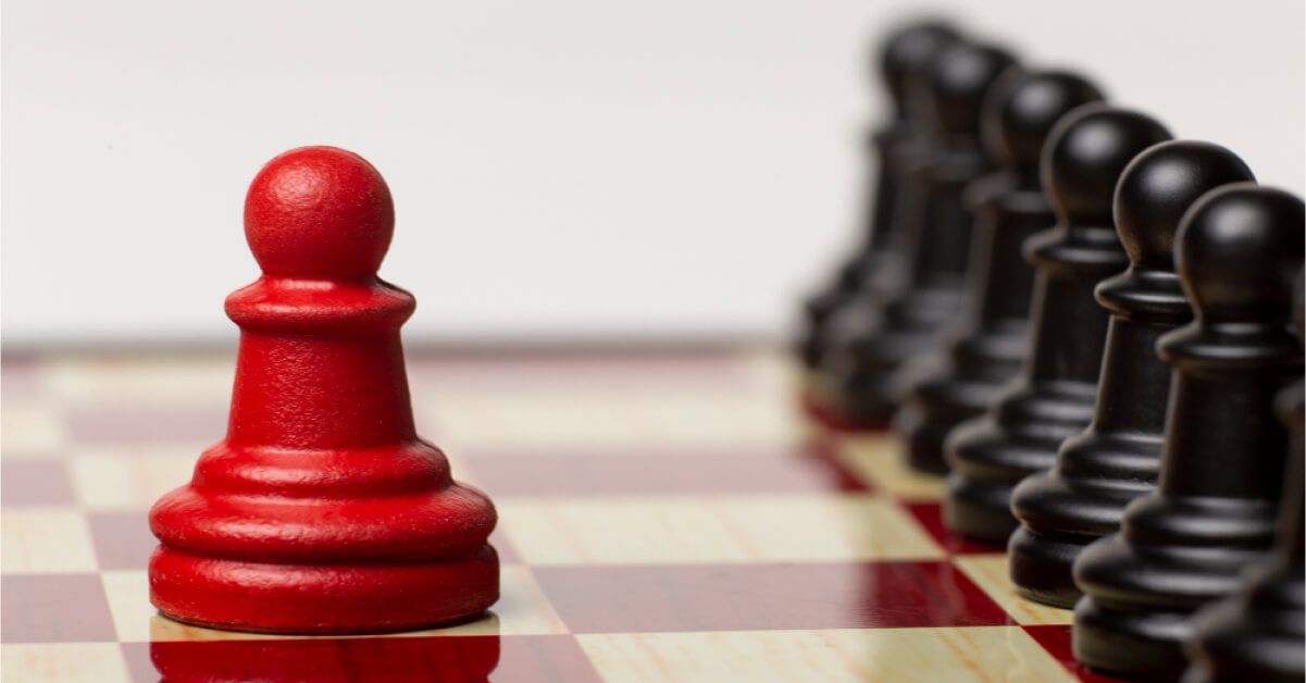 Red pawn next to a series of black pawns