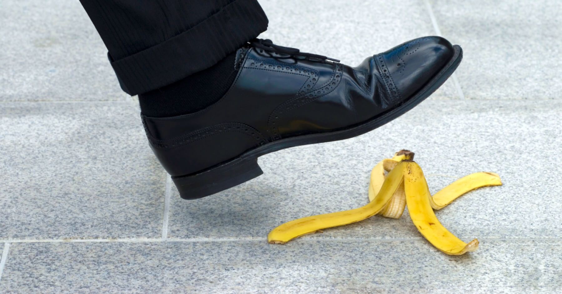 Person about to place their foot on a banana peel