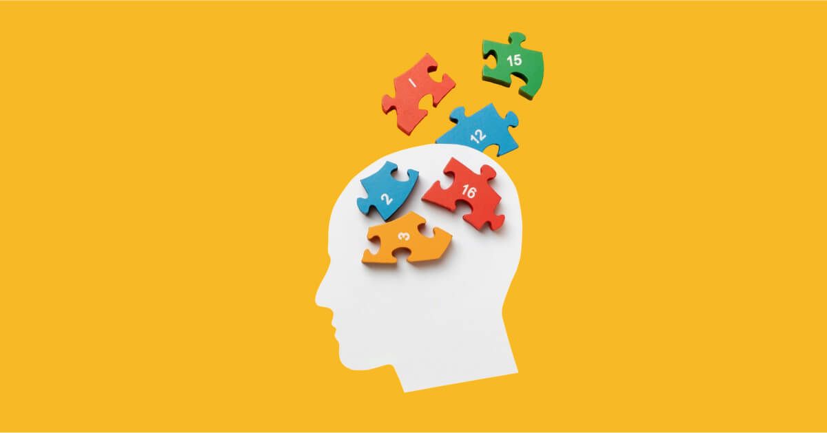 Puzzle pieces over a cutout of a head