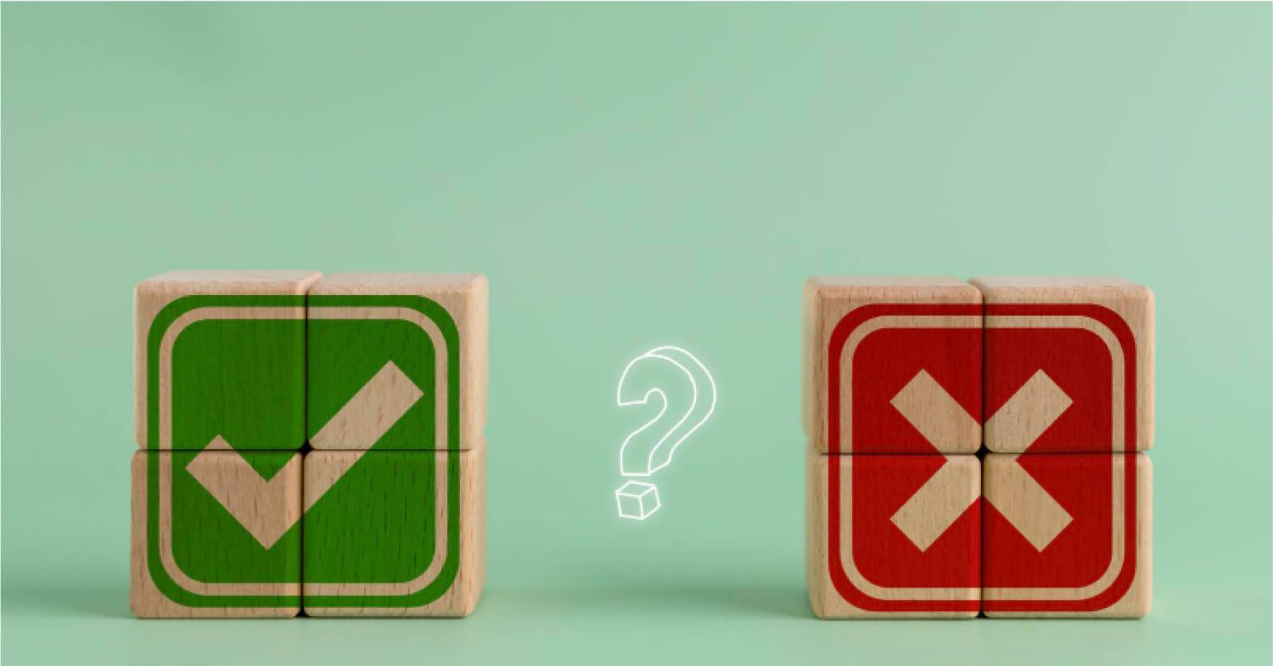 Stacks of wooden blocks forming green tick and red cross