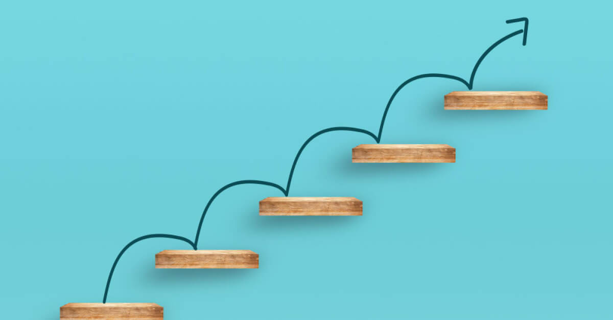 Looping upward arrow on a set of wooden blocks