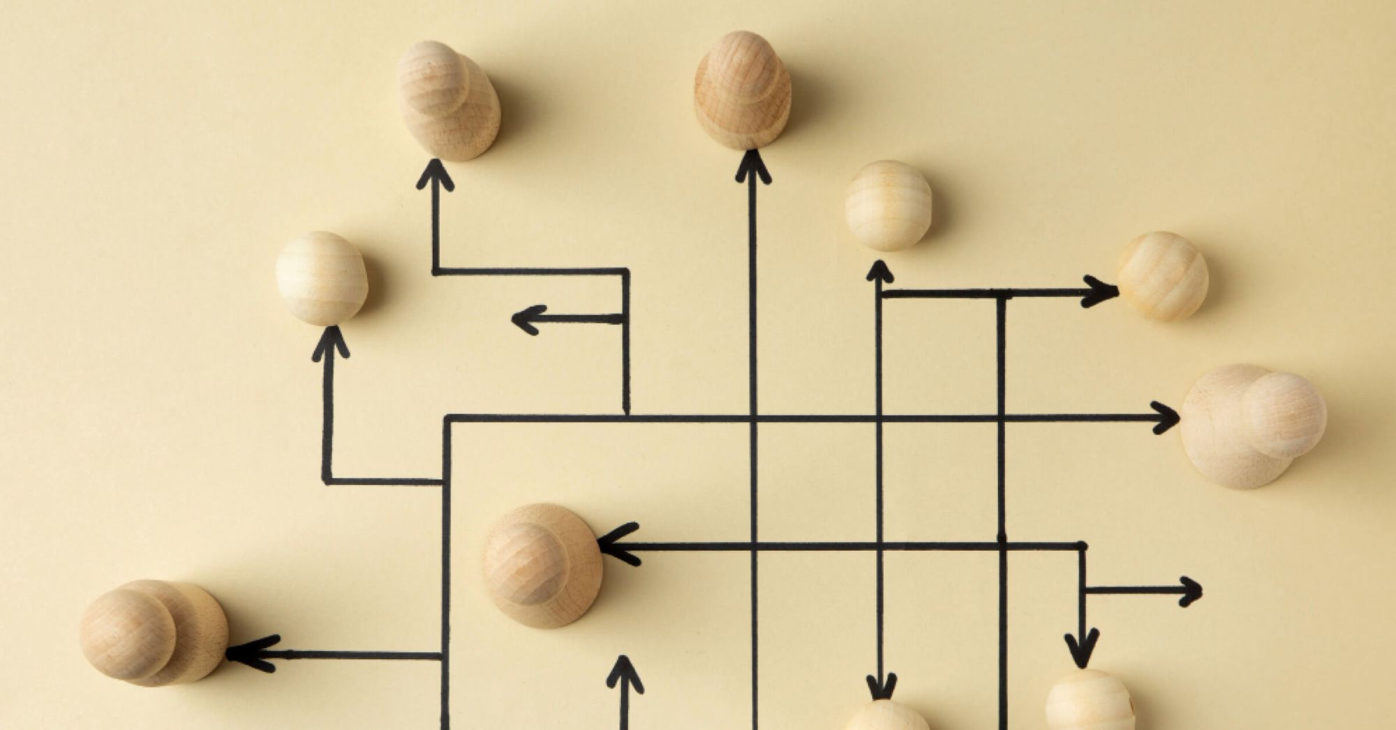 Wooden pawns with interconnecting black arrows