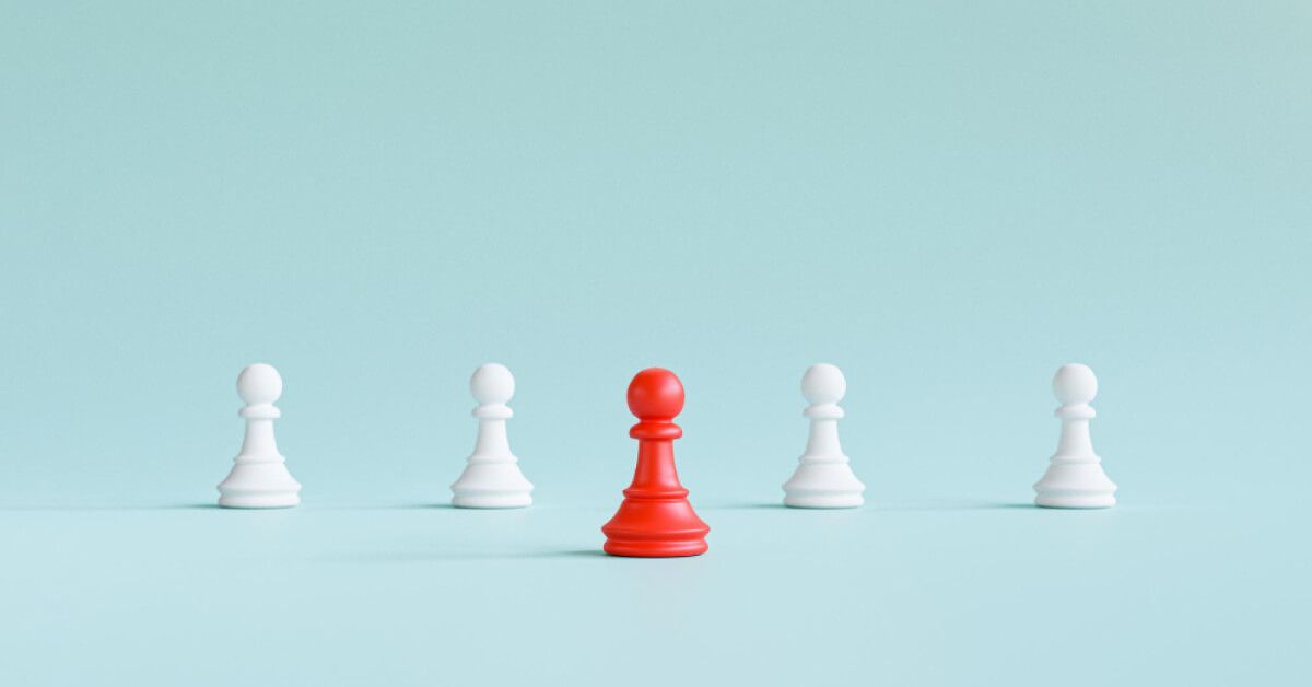 Red pawn in front of a series of white pawns