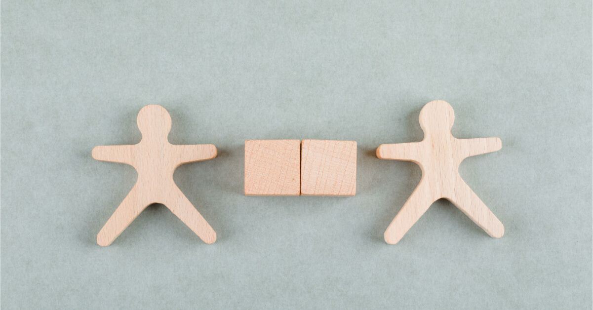 Wooden figures alongside wooden blocks