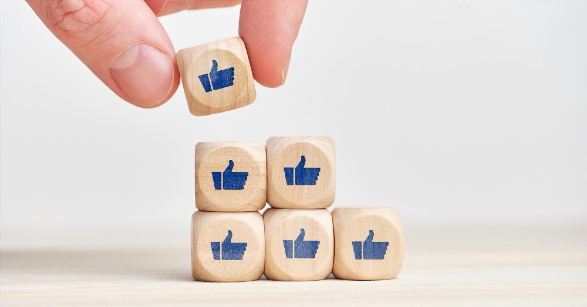 Thumbs up on wooden blocks