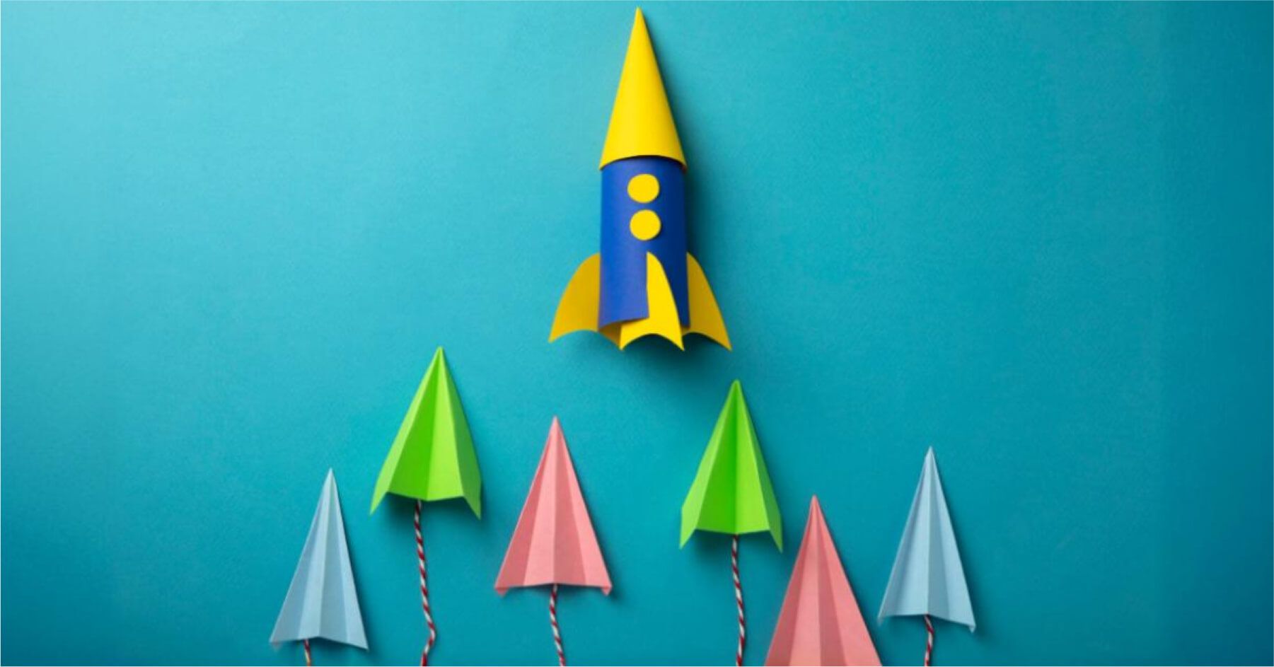 Coloured paper planes trailing a rocket