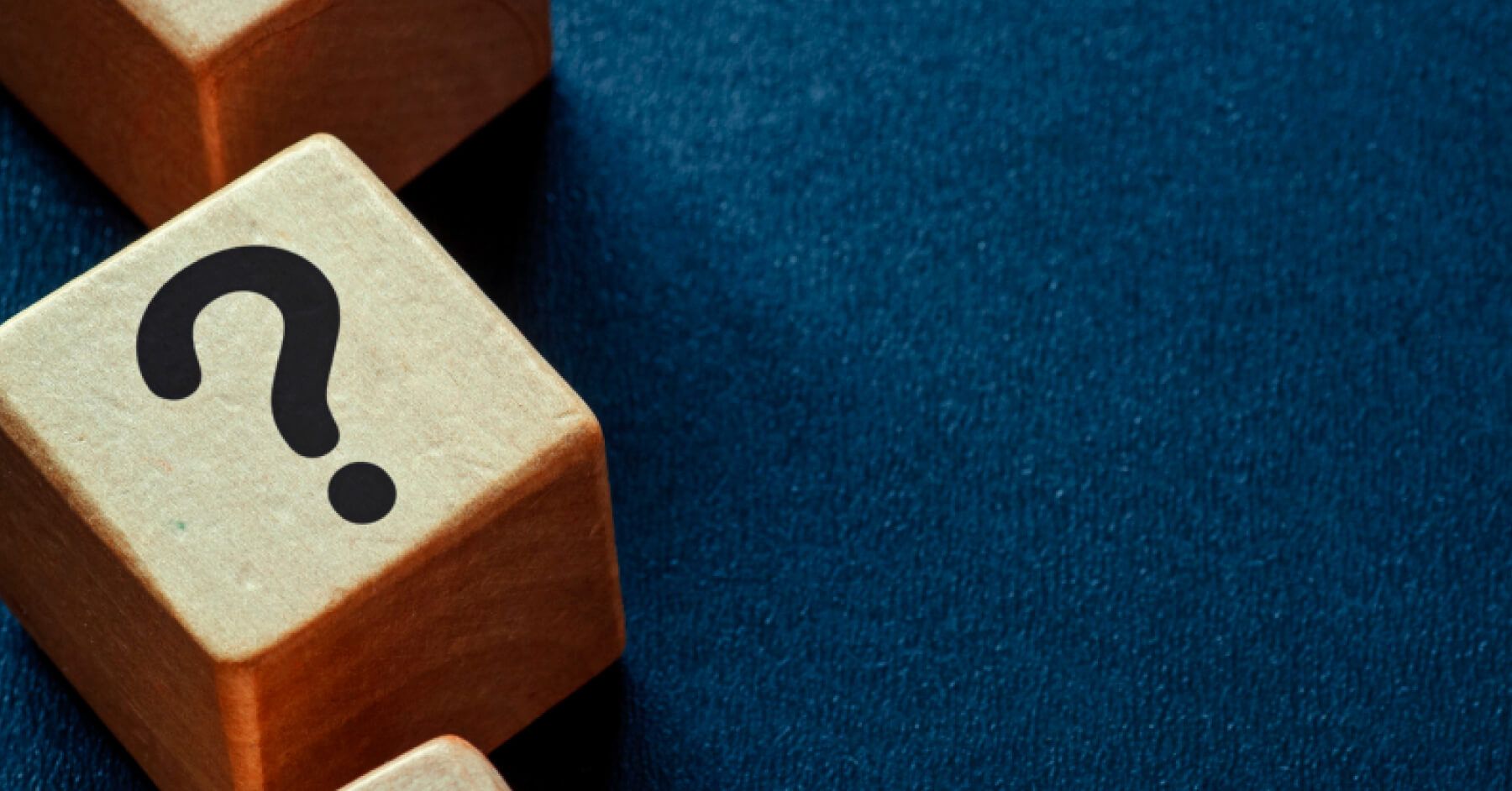 Wooden blocks with question marks on them