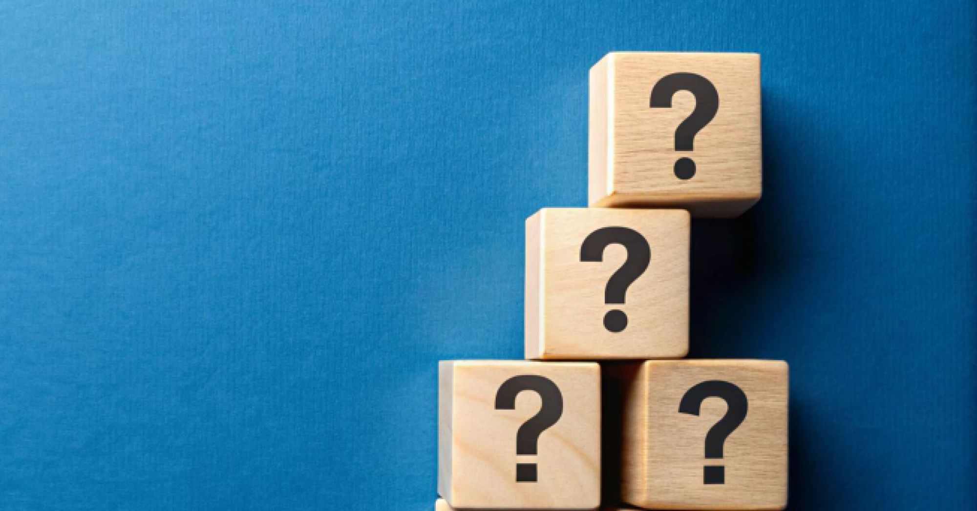 Wooden blocks of question marks stacked on top of each other