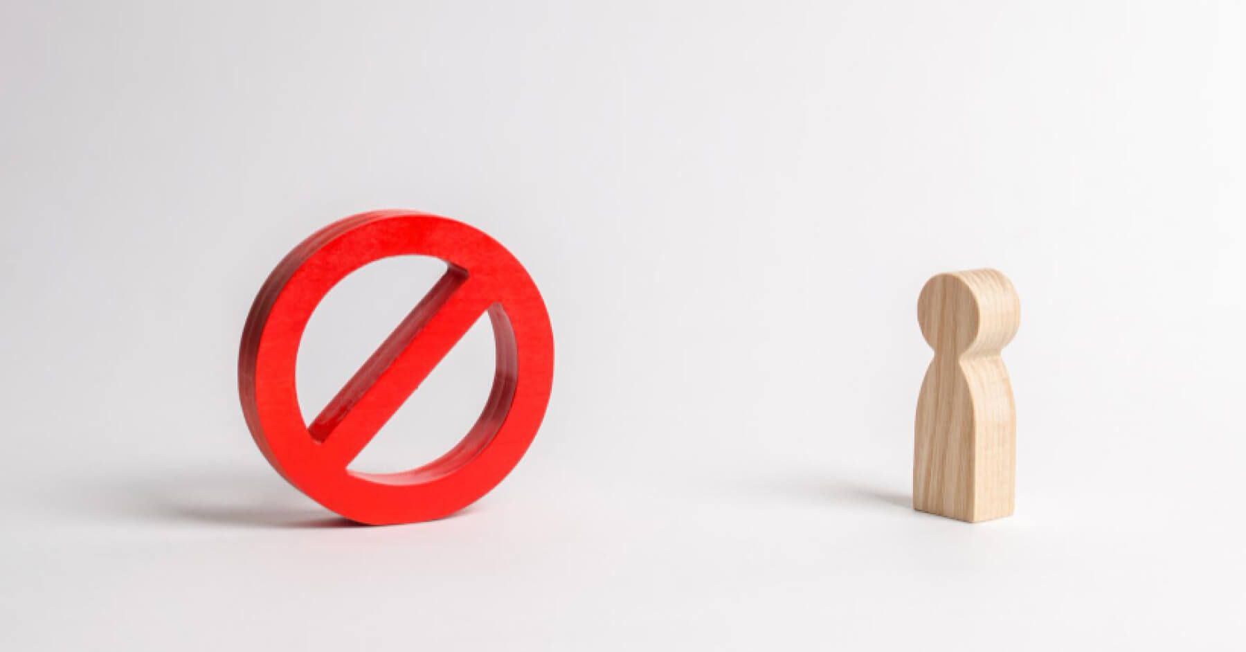 Wooden pawn and a red blocker