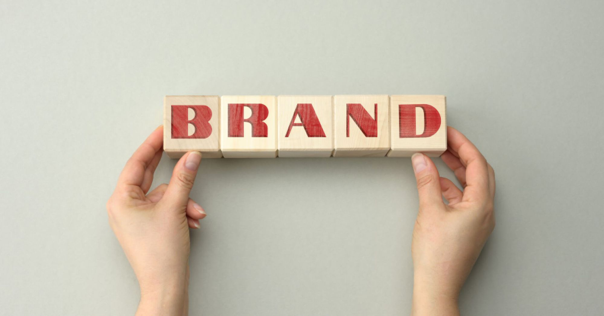 Wooden block arrangement that reads the word Brand