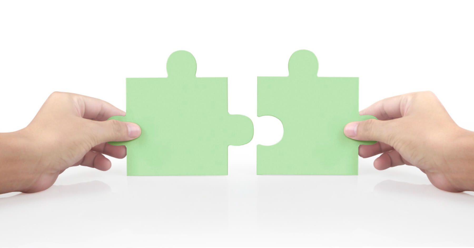 Hand of connecting jigsaw puzzle