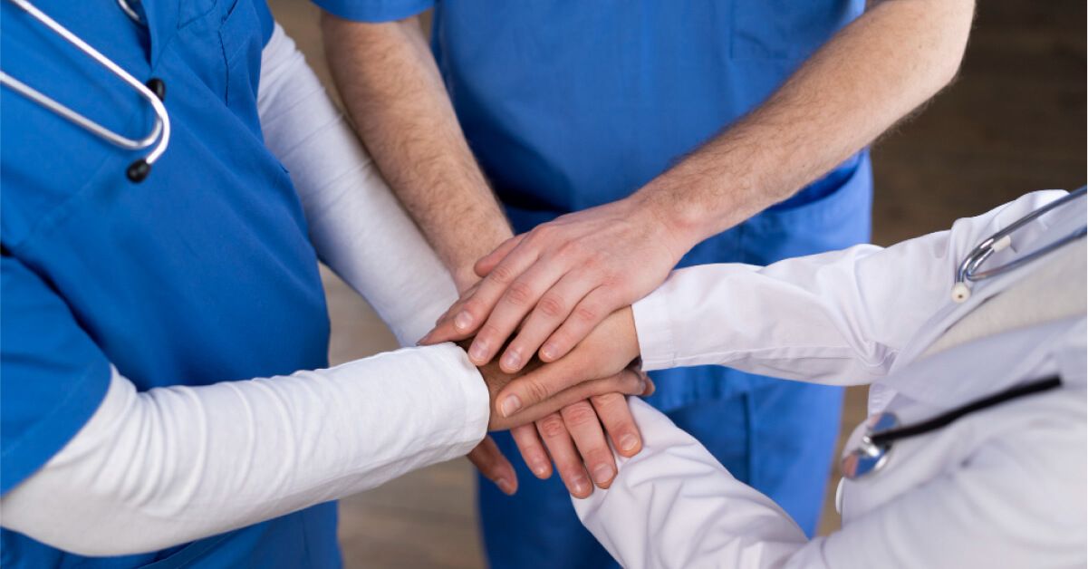 Healthcare workers are standing together closely
