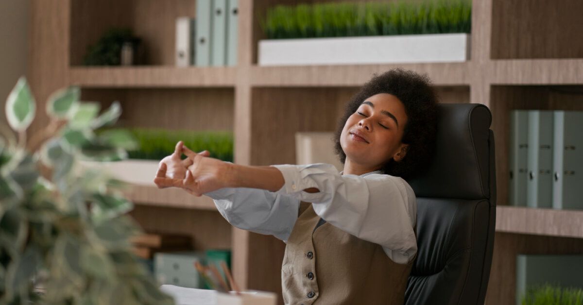 A woman stretching in her office after a long day of work