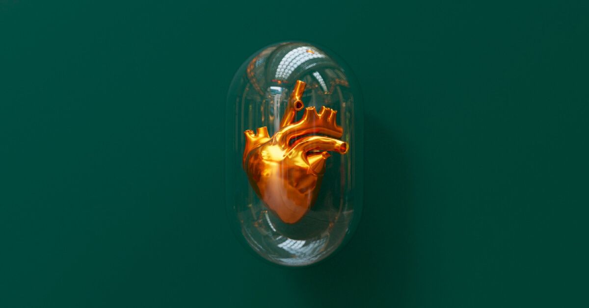 a golden heart inside a big glass capsule