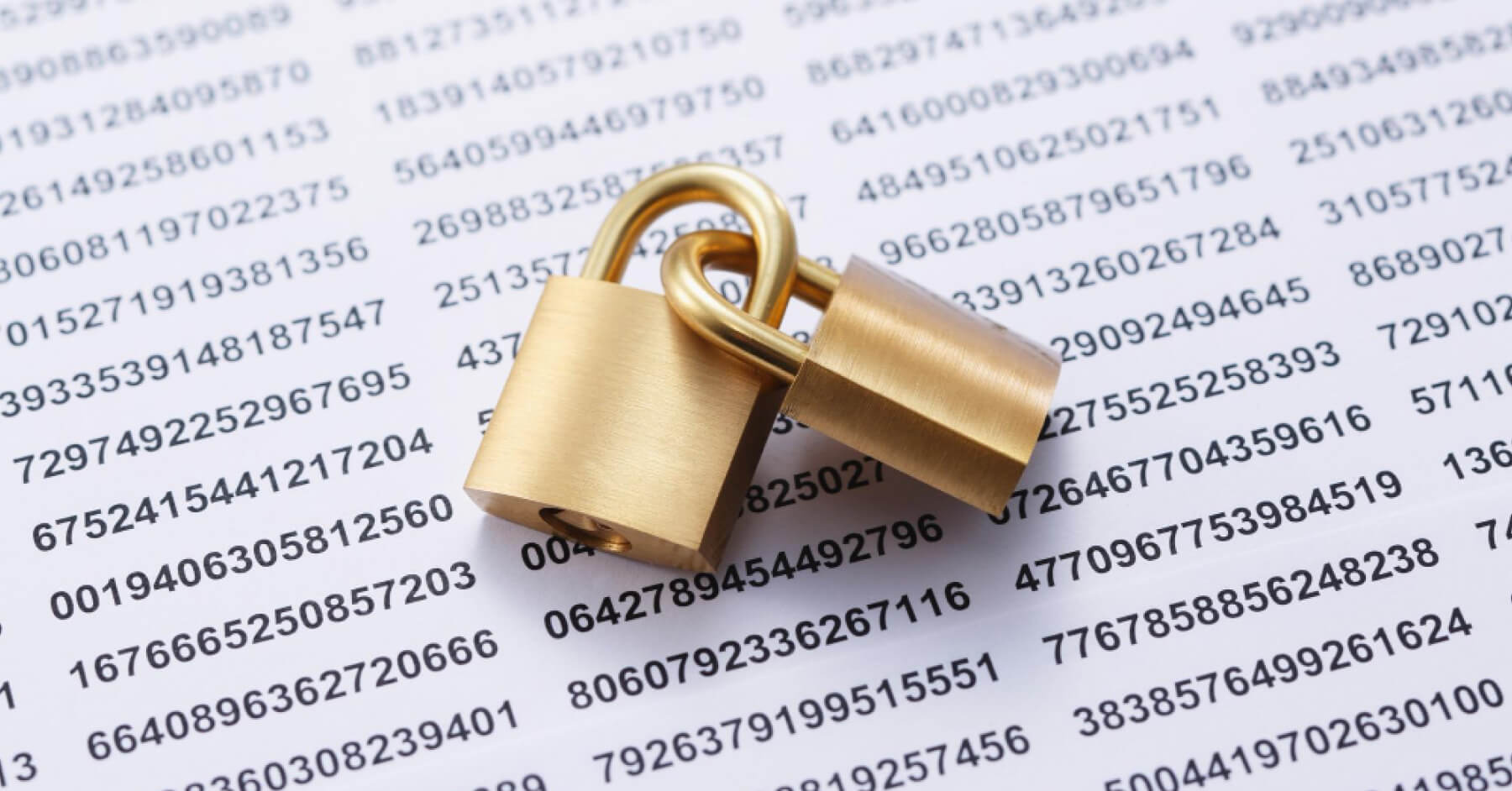 Interlocked golden padlocks over some reports