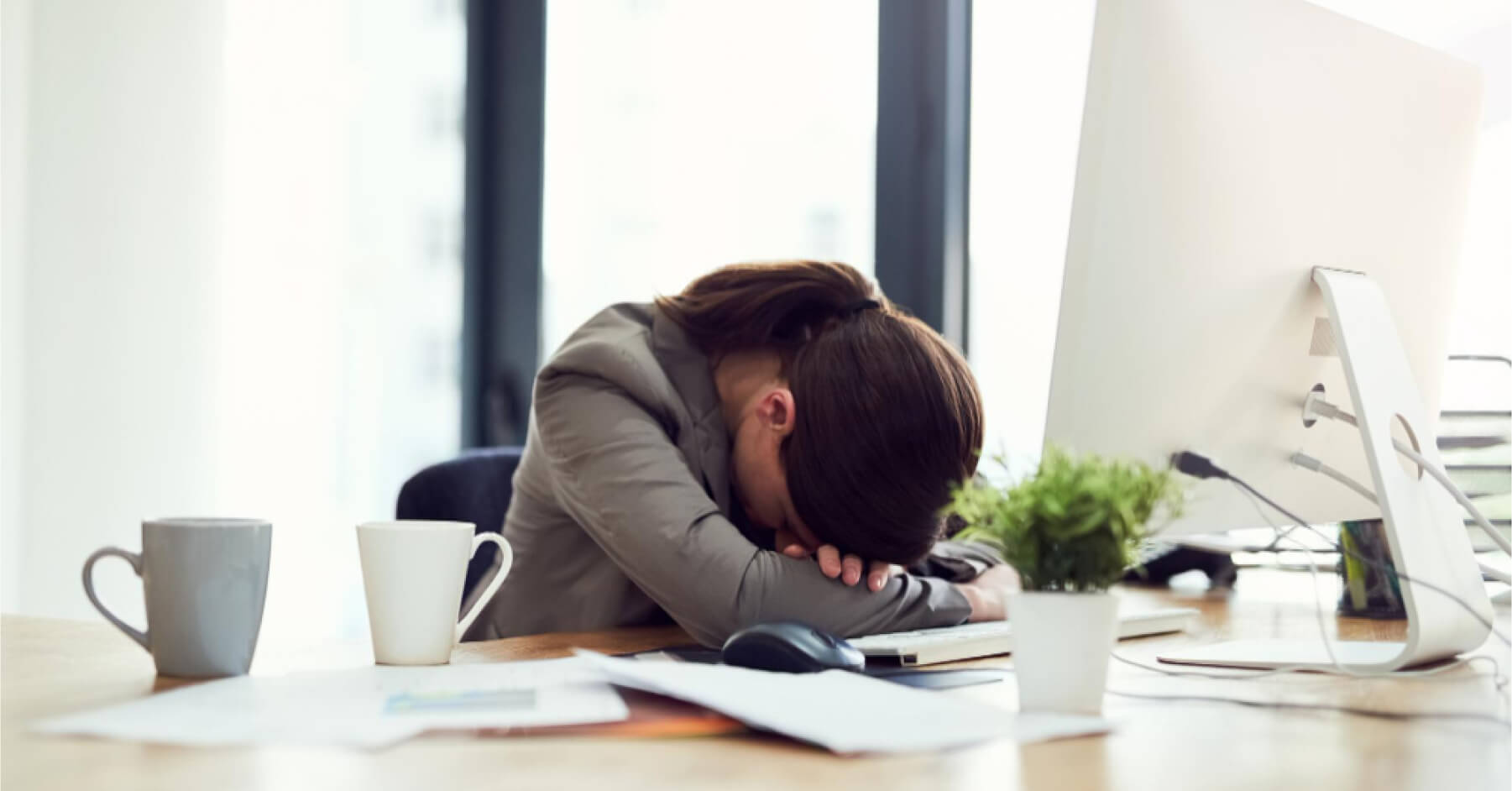 Frustrated employee in front of a desktop