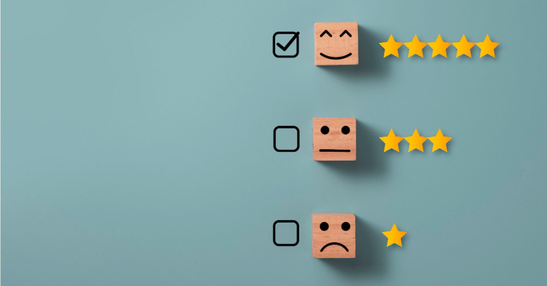 Wooden blocks with emoticon faces and rating scales next to them