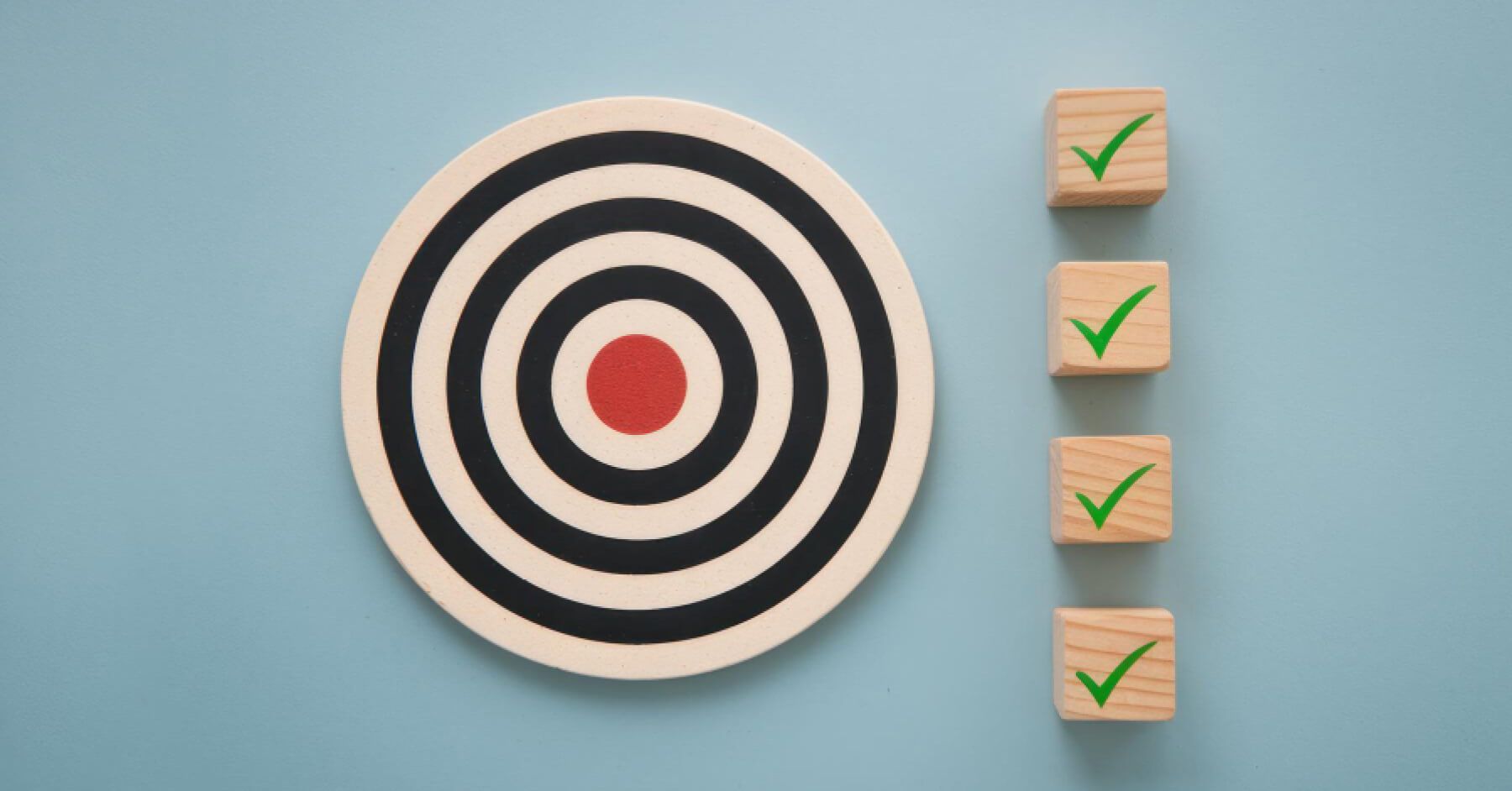 Wooden blocks with tick marks, next to a target board