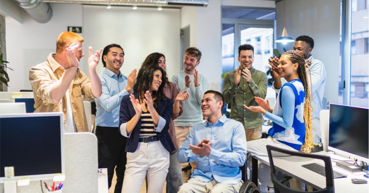 Employees clapping together