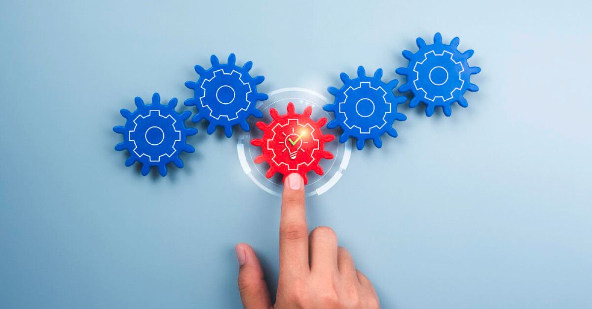 Person interacting with a set of gears and holographic visuals