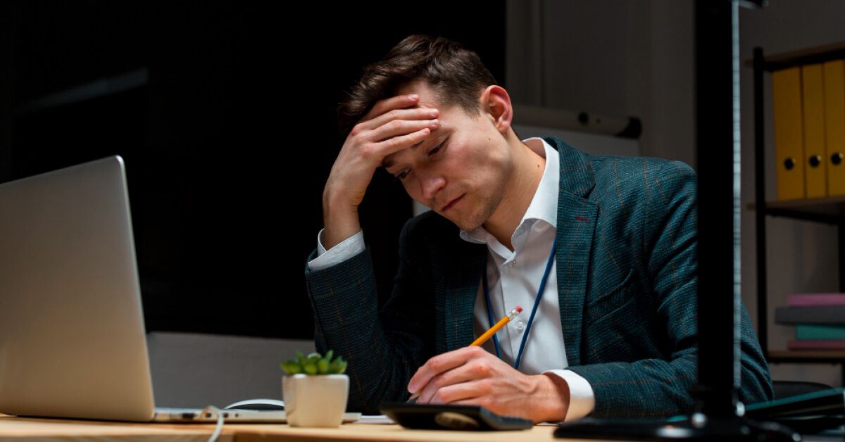 Stressed person in front of a laptop screen