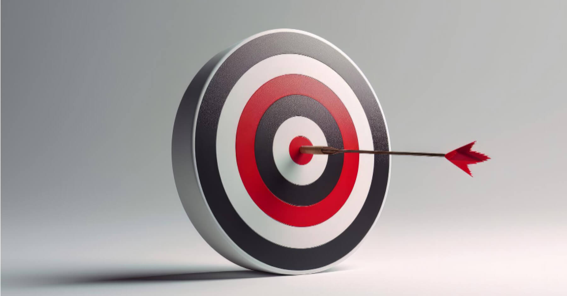 Red dart hitting the center of a target board