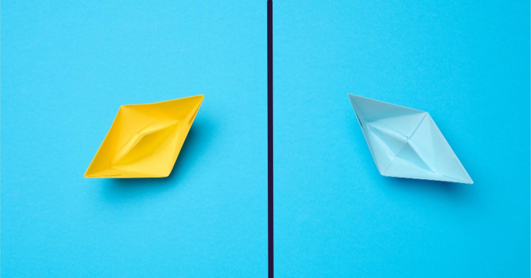 Blue and yellow paper boats against a blue backdrop