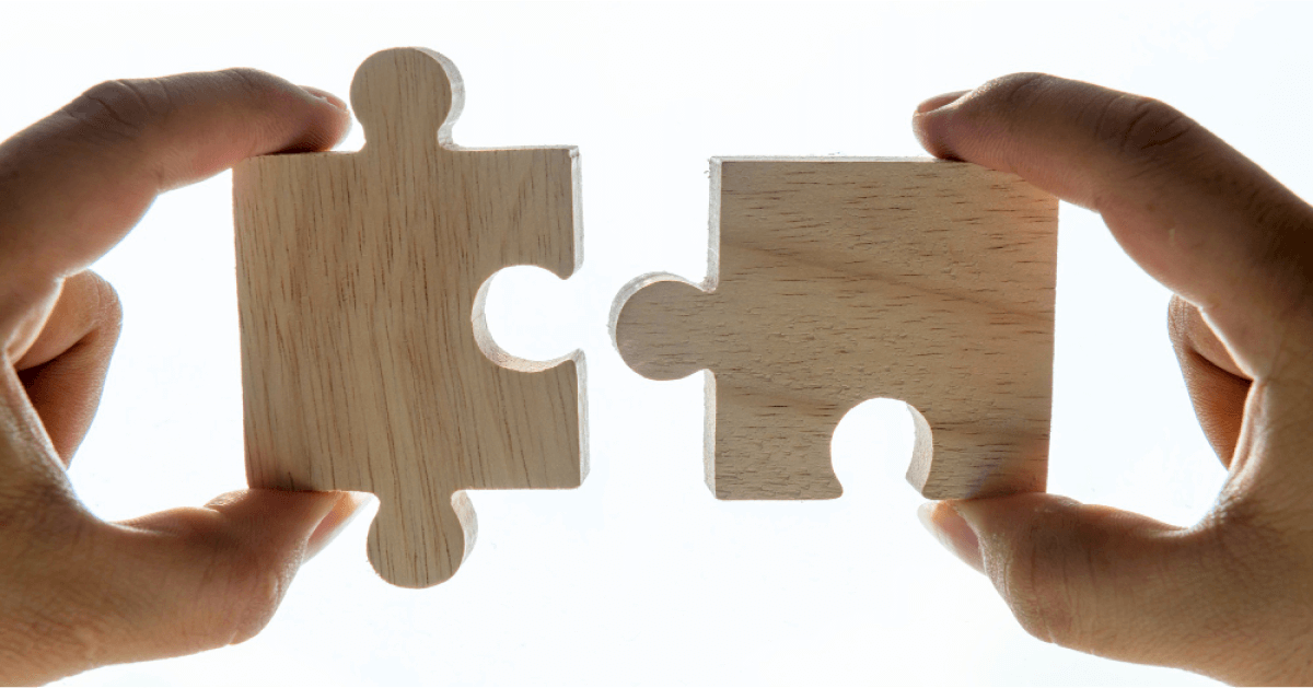 Person linking two puzzle pieces