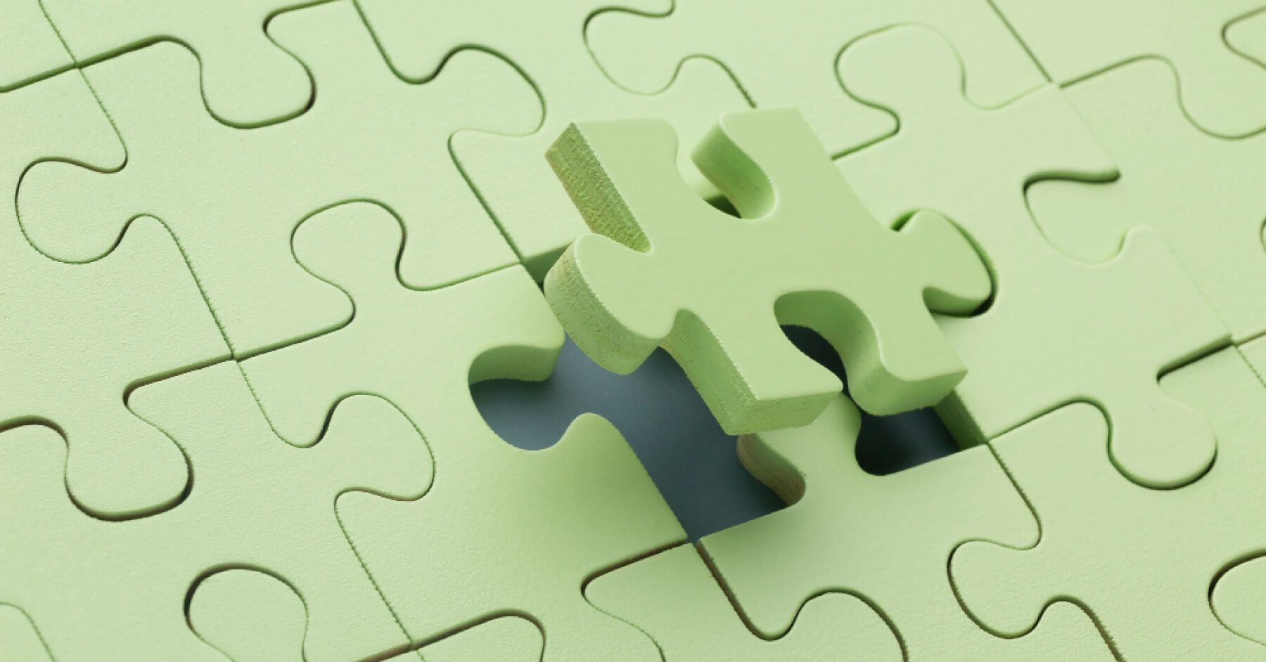 Green puzzle piece fitting in