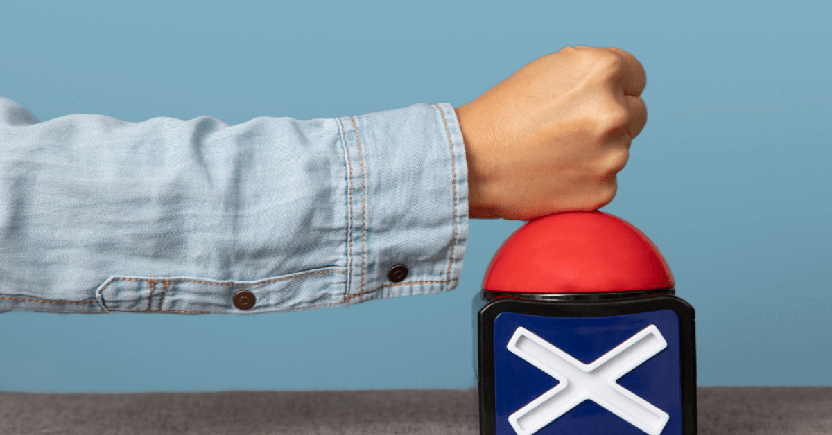 Person hitting a red buzzer