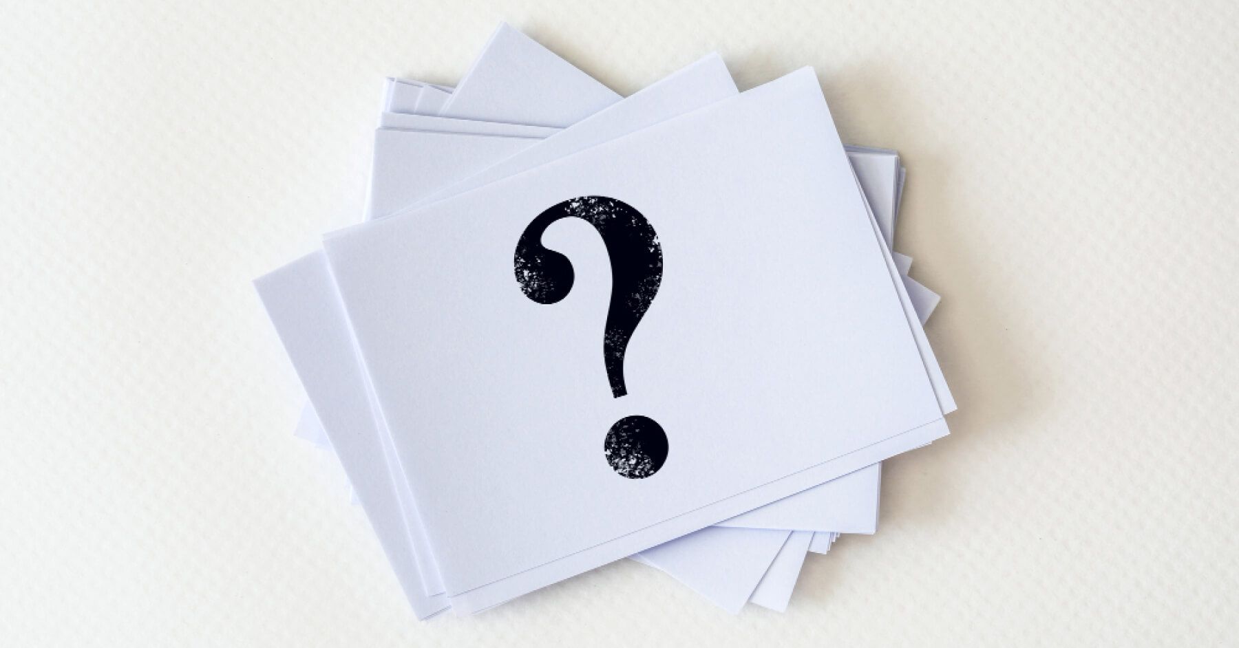 Stack of cards with question marks on them