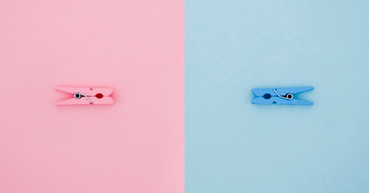 A blue clip and a pink clip placed facing each other