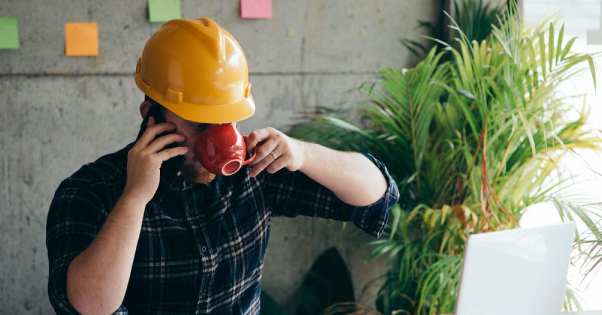 Blue collar worker working calmly sipping coffee
